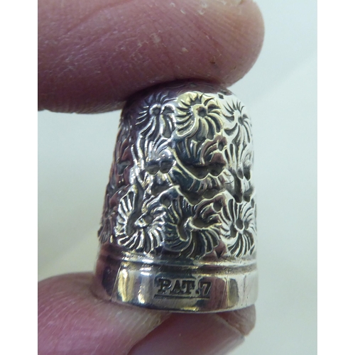 186 - White metal collectables: to include napkin rings; and thimbles