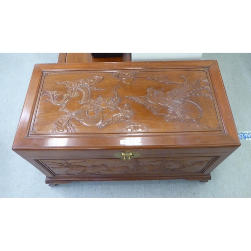 205 - A mid 20thC Chinese fruitwood chest, allover carved with dragons, raised on bracket feet  24