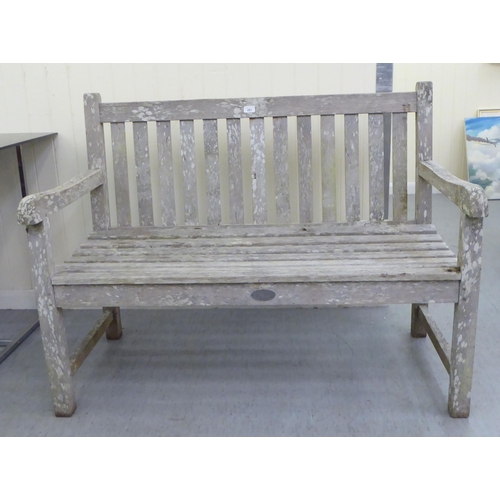 207 - A two person teak garden bench of slatted construction  48