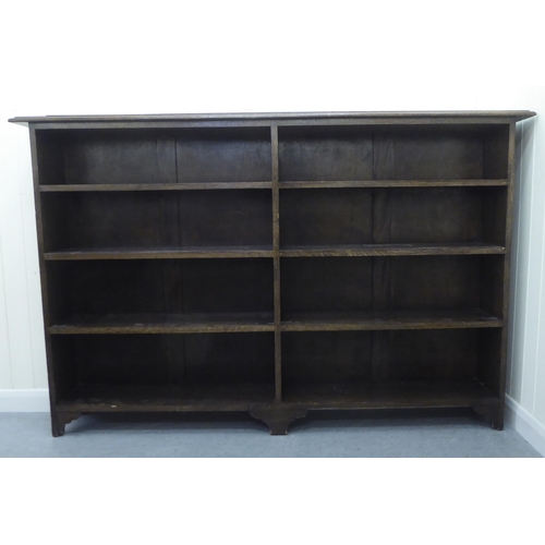 22 - A modern oak dwarf bookcase, comprising two banks of four open shelves, raised on bracket feet  44