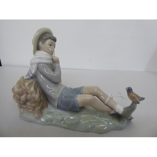 223 - Four Lladro figures: to include a young boy holding a fishing rod  9