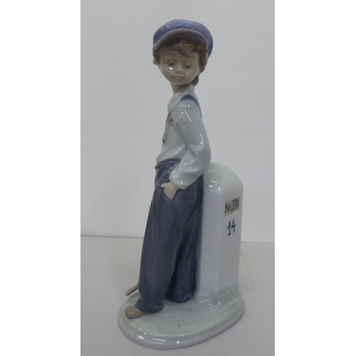 223 - Four Lladro figures: to include a young boy holding a fishing rod  9