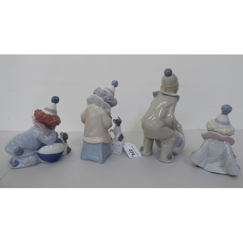 224 - Four Lladro figures, clowns, one playing an accordion for a puppy  6