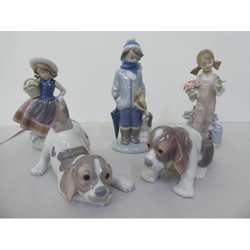 228 - Five Lladro figures: to include a boy dressed in winter clothing, walking a dog  8