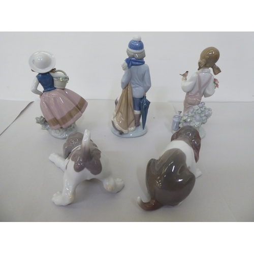 228 - Five Lladro figures: to include a boy dressed in winter clothing, walking a dog  8