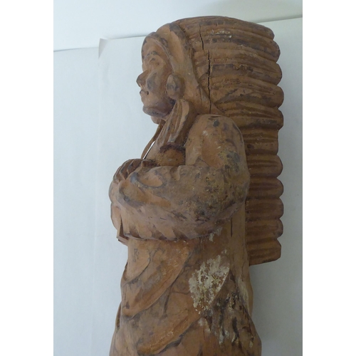 239 - A modern carved wooden figure, a native American  23.5