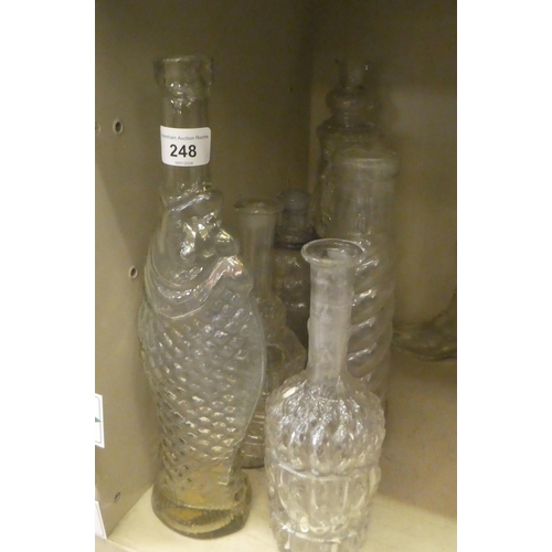 248 - Glass bottles and decanters  various shapes & sizes: to include an example in the form of a... 