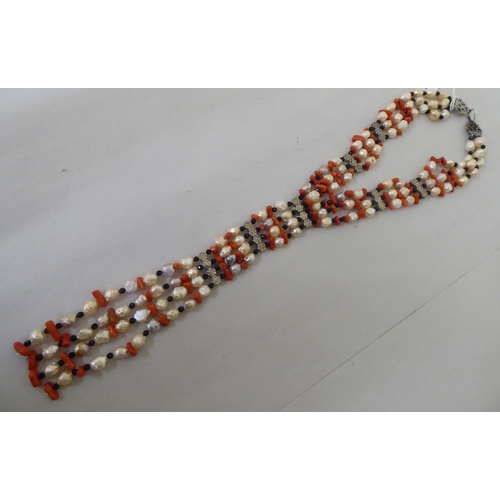 249 - A pendant necklace, comprising strands of pearl, coral, agate and white metal