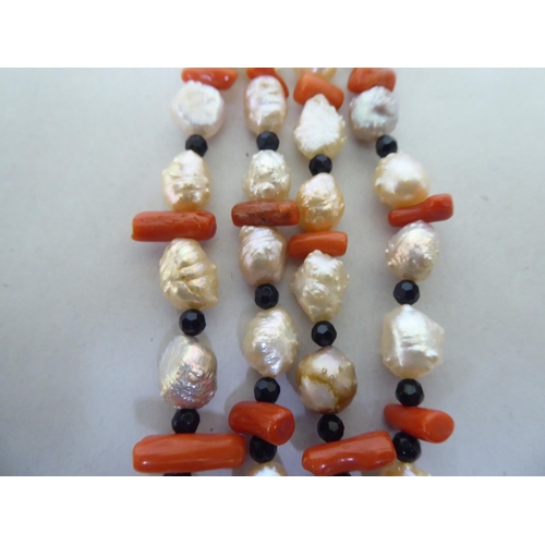 249 - A pendant necklace, comprising strands of pearl, coral, agate and white metal