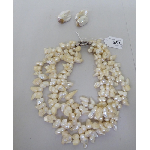 258 - A pair of pearl earrings, stamped Monies; and a similar pearl necklace, united by a white metal clas... 