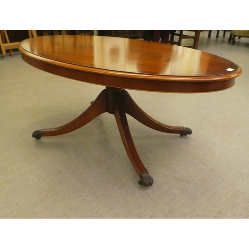 276 - A modern mahogany finished coffee table, raised on a splayed pedestal base  21