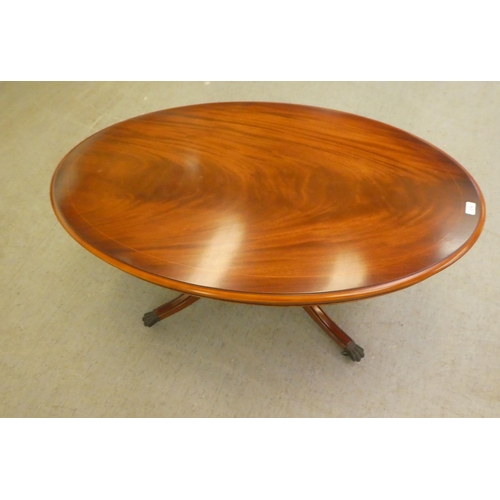 276 - A modern mahogany finished coffee table, raised on a splayed pedestal base  21