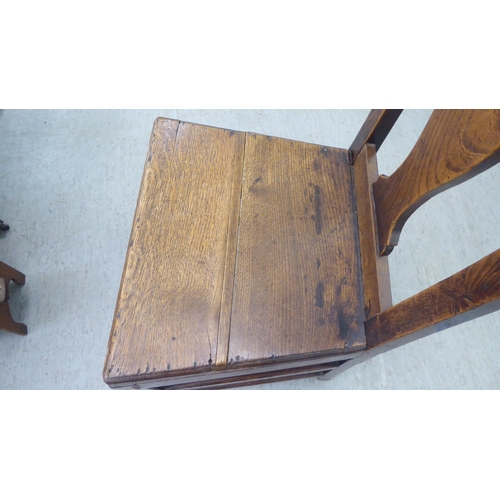 283 - A George III ash and oak framed hall chair with a solid seat, raised on square, tapered legs