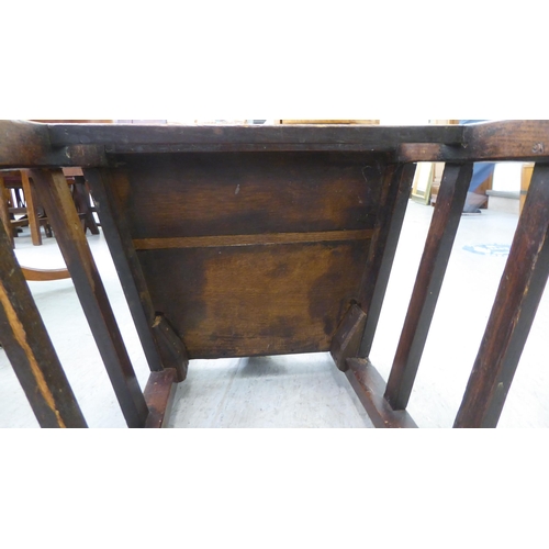 283 - A George III ash and oak framed hall chair with a solid seat, raised on square, tapered legs