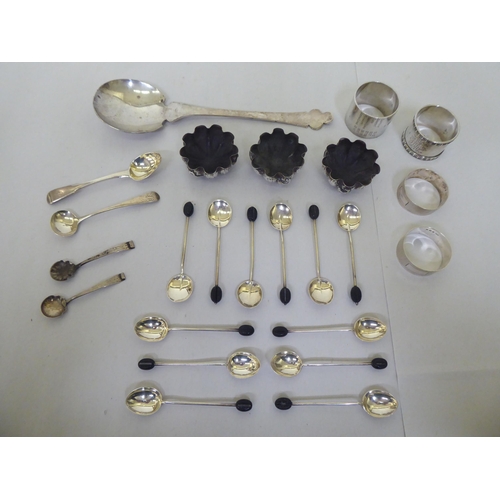 292 - Silver items: to include a set of three salt cellars, a serving spoon and four various napkin rings&... 