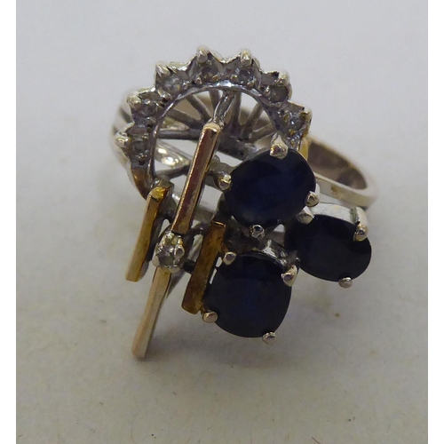 297 - A yellow and white metal Art Deco design ring, set with diamonds and sapphires