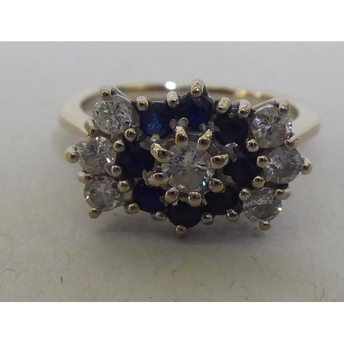 305 - An 18ct gold diamond and sapphire, fan design cluster ring