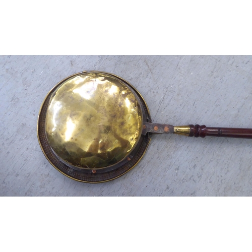 308 - A late 18thC brass bed warming pan, on a turned fruitwood handle  50