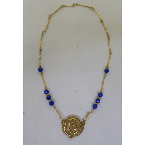 316 - An 18ct gold organic design pendant necklace, set with lapis lazuli beads and a diamond