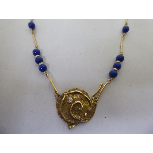 316 - An 18ct gold organic design pendant necklace, set with lapis lazuli beads and a diamond