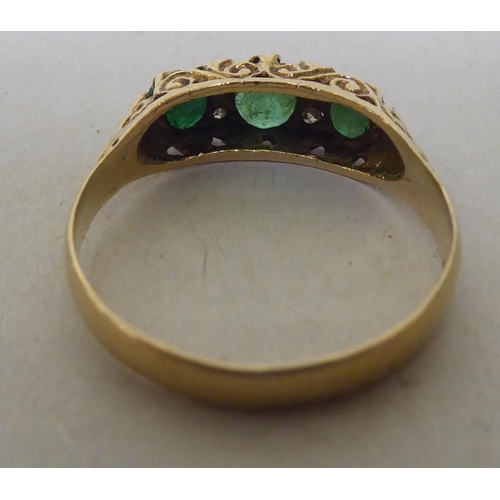 319 - A 9ct gold diamond and emerald ring