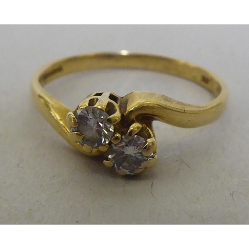 320 - An 18ct gold diamond, two stone crossover ring