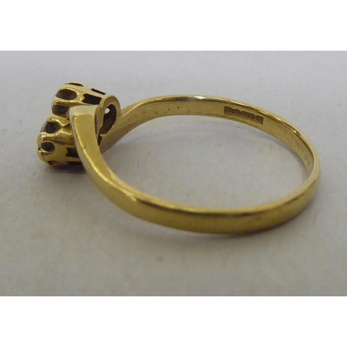 320 - An 18ct gold diamond, two stone crossover ring