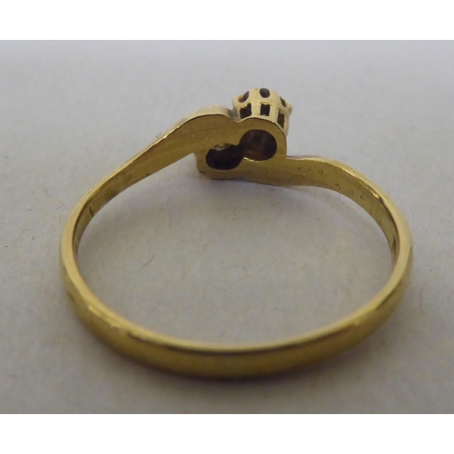 320 - An 18ct gold diamond, two stone crossover ring