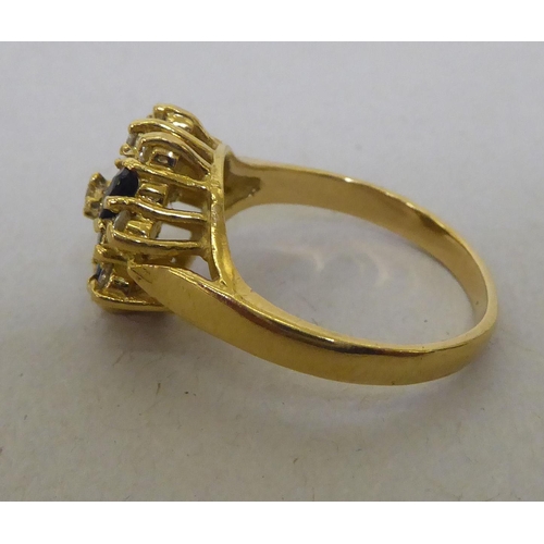 321 - An 18ct gold, diamond and sapphire cluster ring