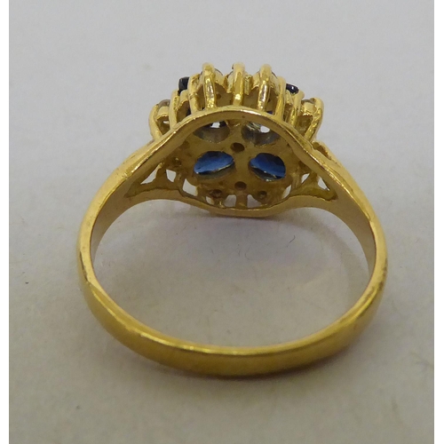 321 - An 18ct gold, diamond and sapphire cluster ring