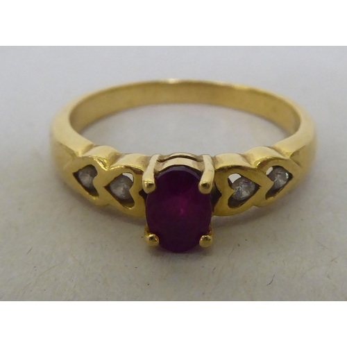 323 - An 18ct gold diamond and ruby ring