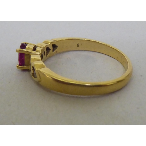 323 - An 18ct gold diamond and ruby ring