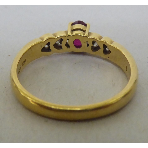 323 - An 18ct gold diamond and ruby ring