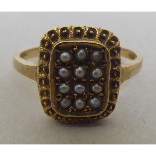 325 - A 9ct gold tablet design ring, set with seed pearls