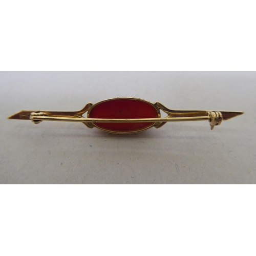 340 - A 9ct gold bar brooch, set with a coral cabochon 