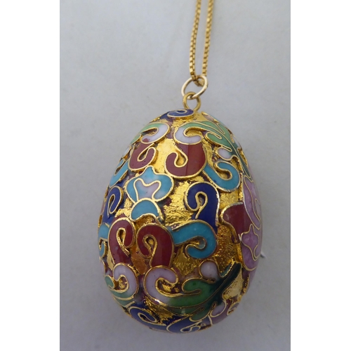 342 - A yellow metal enamelled egg design pendant necklace