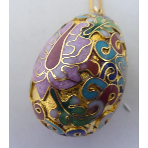 342 - A yellow metal enamelled egg design pendant necklace