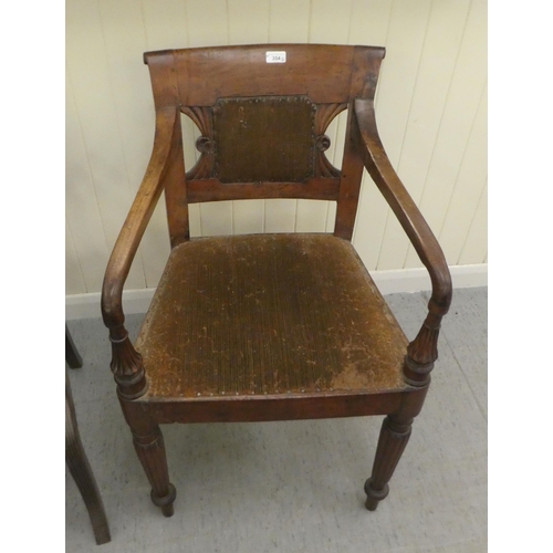 354 - A Regency mahogany framed dining chair with a bar back and swept open arms, raised on turned, reeded... 