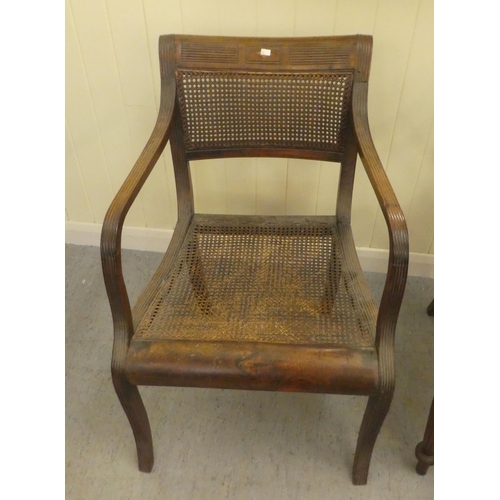 354 - A Regency mahogany framed dining chair with a bar back and swept open arms, raised on turned, reeded... 