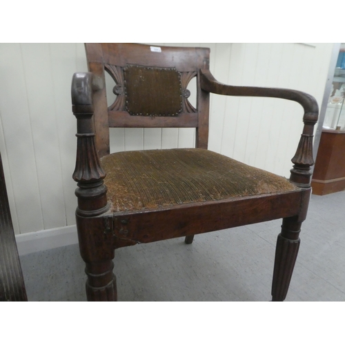 354 - A Regency mahogany framed dining chair with a bar back and swept open arms, raised on turned, reeded... 