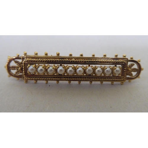 357 - A 9ct gold brooch, set with a row of seed pearls