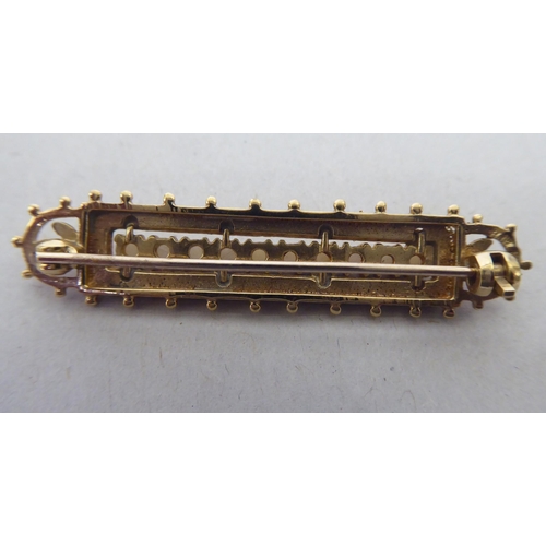 357 - A 9ct gold brooch, set with a row of seed pearls