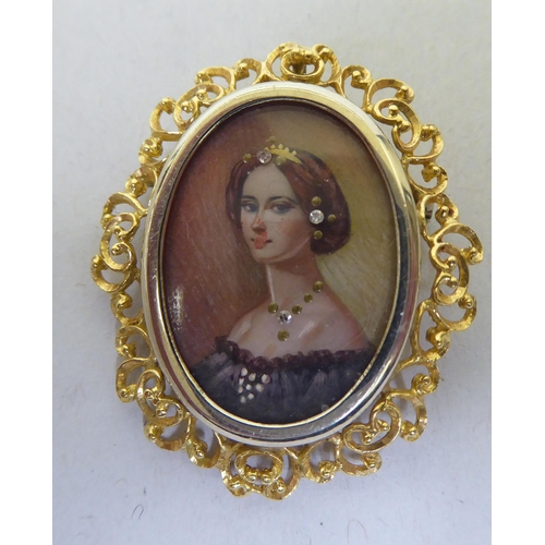 366 - A 9ct gold filigree pendant, set with a painted portrait of a lady