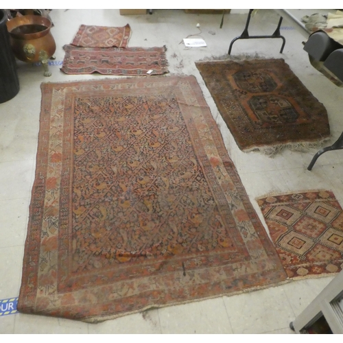 374 - Rugs: to include a Persian example, decorated with floral and geometric patterns, on a red ground&nb... 