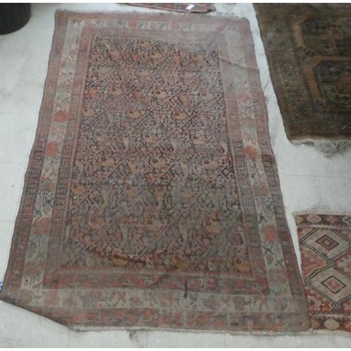 374 - Rugs: to include a Persian example, decorated with floral and geometric patterns, on a red ground&nb... 