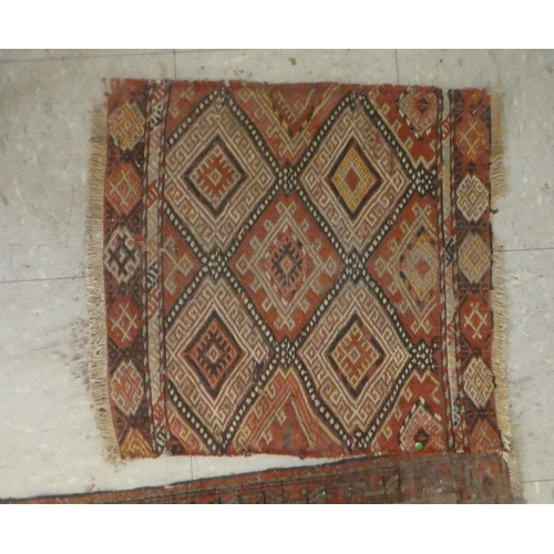 374 - Rugs: to include a Persian example, decorated with floral and geometric patterns, on a red ground&nb... 