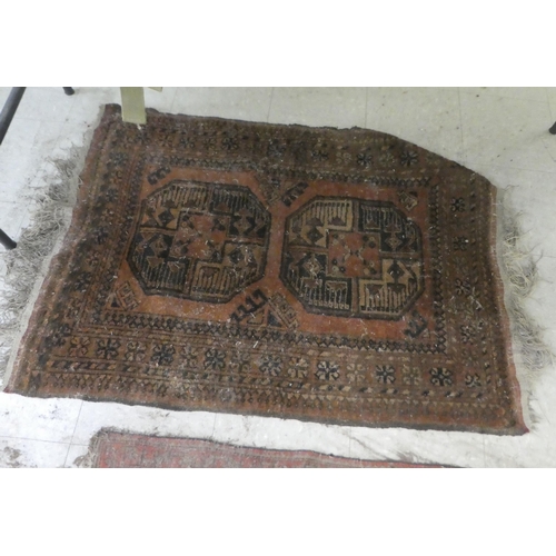 374 - Rugs: to include a Persian example, decorated with floral and geometric patterns, on a red ground&nb... 