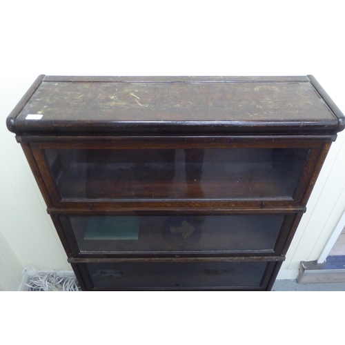 375 - An oak Globe Wernicke four section, glazed front bookcase  49.5