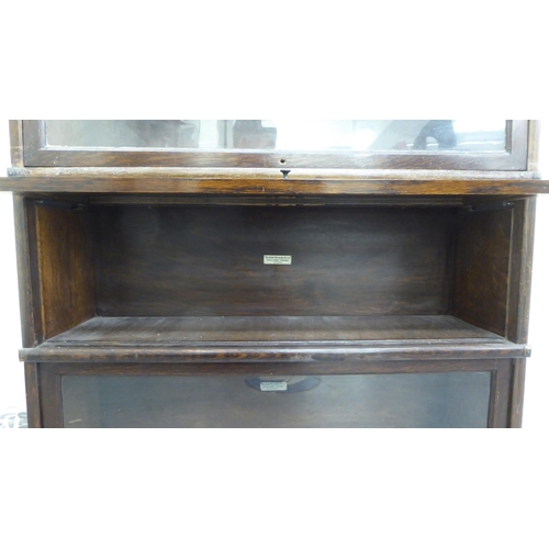 375 - An oak Globe Wernicke four section, glazed front bookcase  49.5