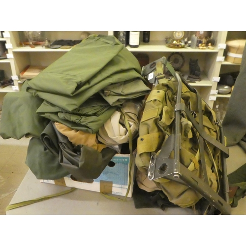52 - Military uniform accessories: to include two rucksack frames; trousers; waterproofs; and other garme... 